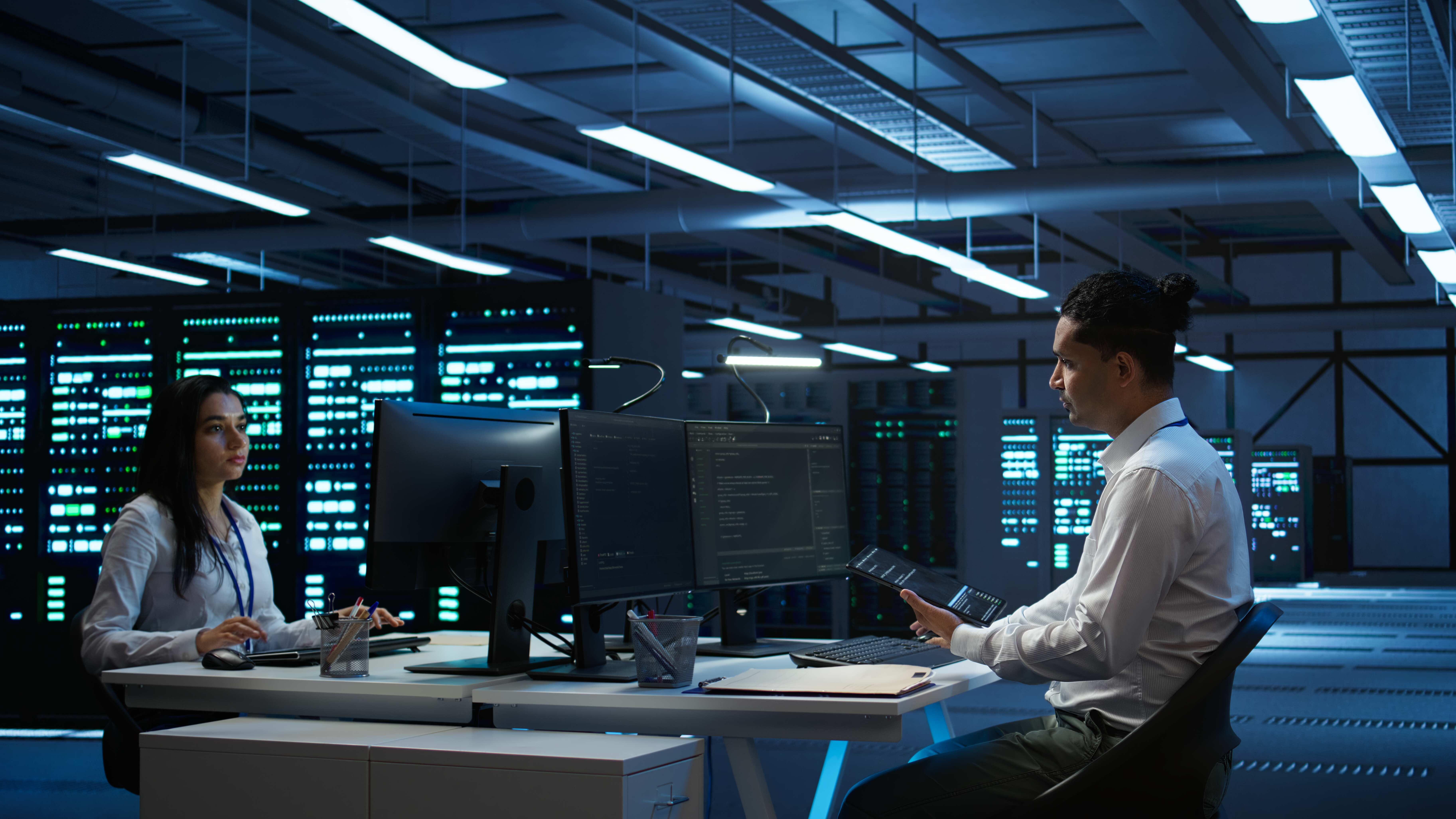 IT staff member in server hub establishing performance benchmarks